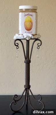 A jar of Justin's Maple Almond Butter on a small pedestal.