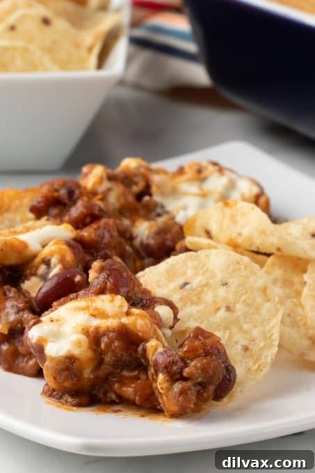 Easy Three Ingredient Chili Cheese Delight 11 A cheese dip with chili, glistening with melted cheese.