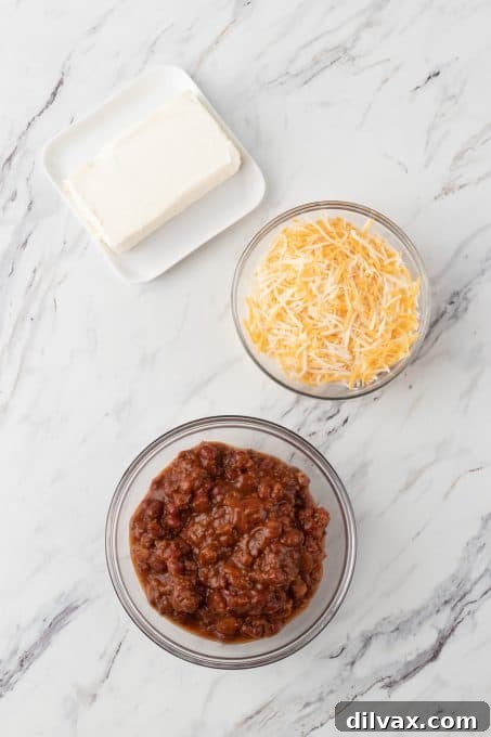 Easy Three Ingredient Chili Cheese Delight 4 Ingredients for 3-Ingredient Chili Cheese Dip including cream cheese, shredded cheese, and canned chili.