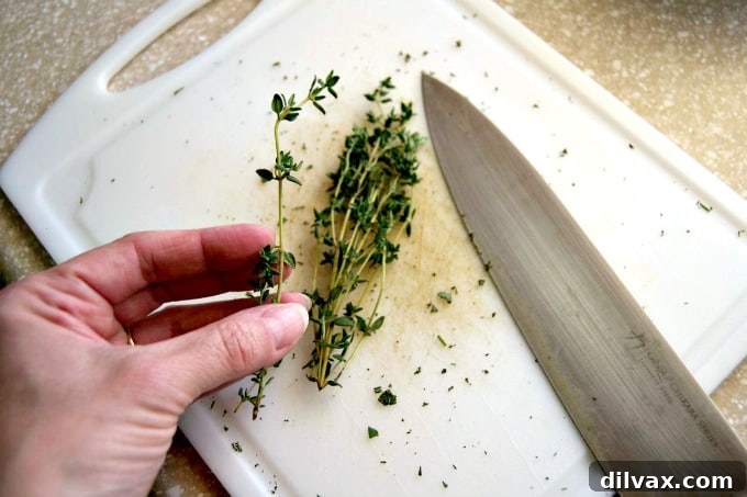 Effortlessly Destemming Fresh Herbs 4 A simple trick for quickly removing fresh rosemary and thyme leaves from their stems, making herb prep a breeze.