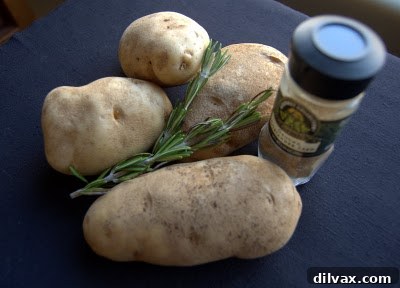 Close-up of freshly baked rosemary potato wedges with a golden, crispy exterior.