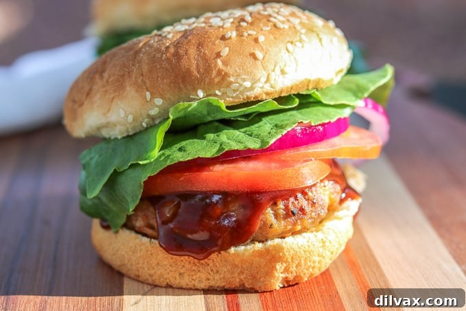 Another view of a cheesy spiced pork burger, showcasing the melted cheese and texture.