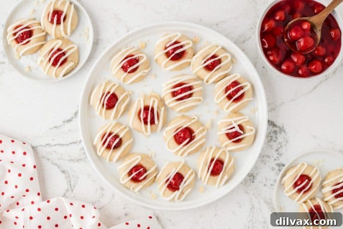 Cherry Thumbprint Delights 2 Soft, buttery thumbprint cookies filled with bright red cherry pie filling and a sweet white glaze.