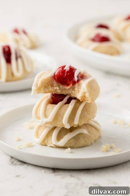 Cherry Thumbprint Delights 11 A Cherry Thumbprint Cookie with a bite taken out, showing the soft interior.