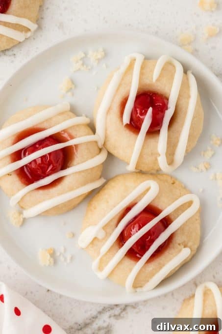 Cherry Thumbprint Delights 3 Cherry Thumbprints with a delicate vanilla glaze dripping over the sides.