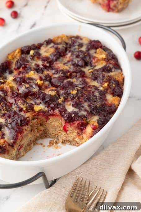 Close-up of a slice of Bread Pudding with cranberries, showing its custardy texture.
