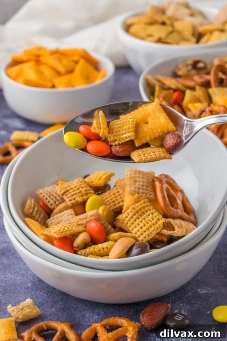 Crackers, pretzels, candy, and cereal mixed together for snacking, arranged beautifully.