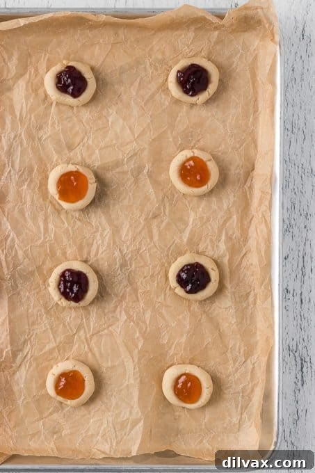 Jewel Box Cookies 6 Buttery cookie dough balls filled with fruit preserves, ready to be baked.