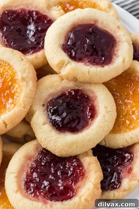 Classic jam-filled Thumbprint Cookies with apricot and raspberry preserves, a holiday tradition.