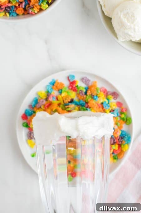 Fruity Cereal Milkshake 5 Decorating the rim of a milkshake glass with colorful rice cereal.