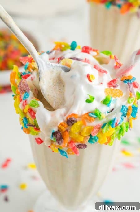 Fruity Cereal Milkshake 9 A spoon in a milkshake made with a favorite breakfast cereal.