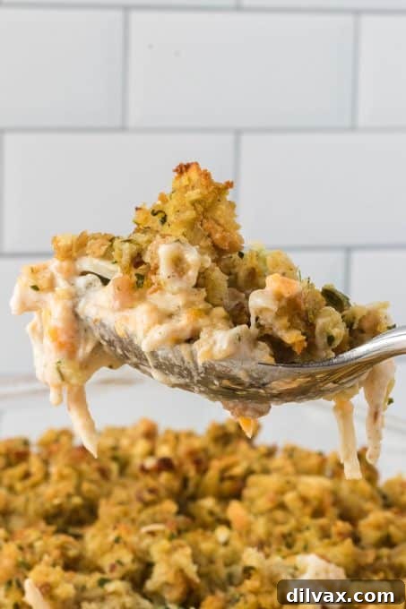 A spoonful of an easy casserole made with chicken, broccoli and stuffing.