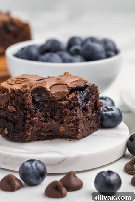 Decadent Blueberry Brownies 10 Brownies bursting with fresh blueberries, a top-down view.