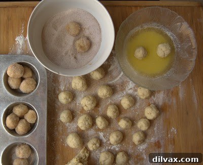 Dough balls being rolled in cinnamon sugar