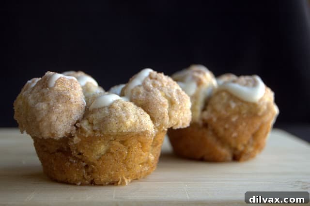 A basket full of warm Banana Monkey Muffins, some frosted, ready to be enjoyed.