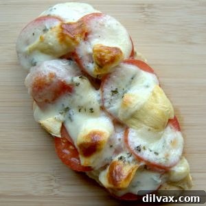 Close-up of baked Artichoke Tomato Chicken with melted provolone cheese