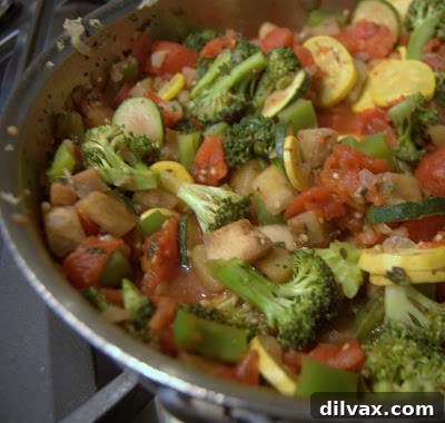 Savory Orzo Ratatouille Bake 5 Vegetables sautéing in a large skillet with tomatoes