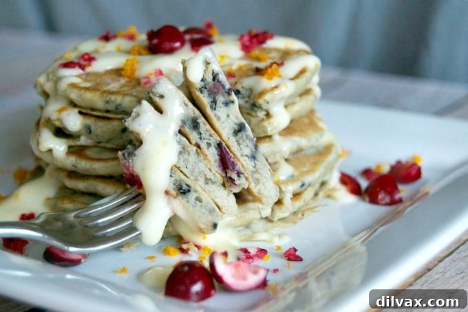 Cranberry Pancakes with Orange Cream Cheese Drizzle, a festive and flavorful breakfast.