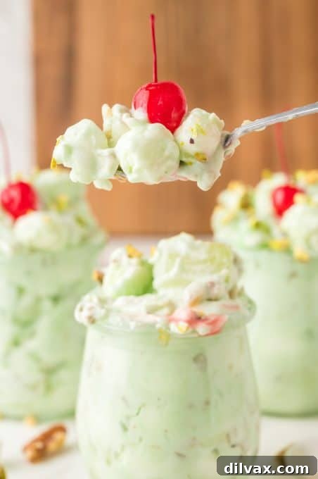 A bite of a Cool Whip fruit and nut salad.