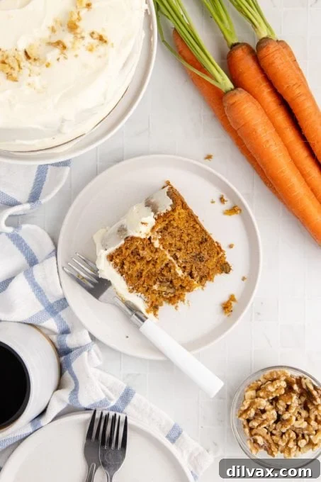 A tempting slice of carrot pineapple cake on a white plate.
