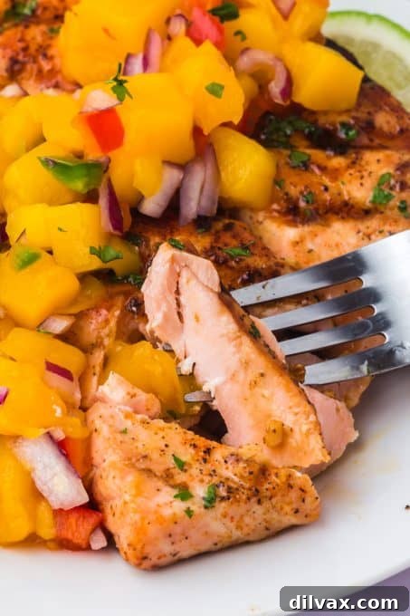 Smoky Salmon with Tropical Mango Relish 11 A forkful of salmon with some salsa made with mango, red onion, and cilantro.