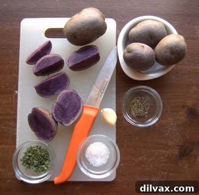 Platter of perfectly roasted blue potatoes with fresh thyme leaves
