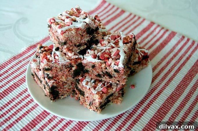 Peppermint Oreo Krispie Bars 3 Close-up of festive Rice Krispies Treats with Winter Oreos and peppermint, topped with Andes Peppermint Crunch. A perfect holiday dessert!