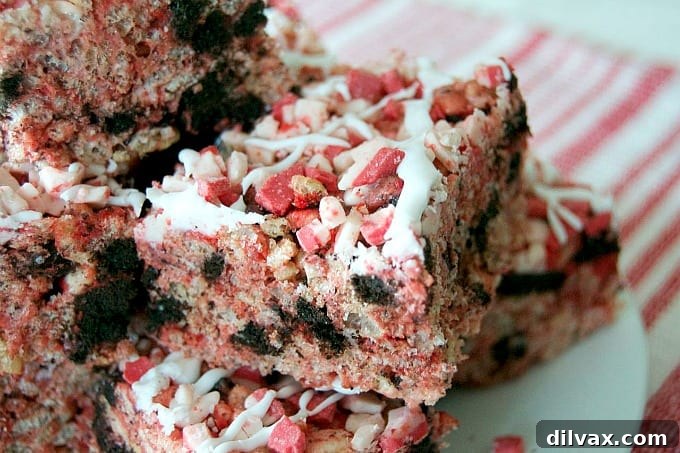 Peppermint Oreo Krispie Bars 6 Close-up view of the delicious Oreo Peppermint Rice Krispies Treats, showing the red Oreo filling and peppermint crunch. An irresistible holiday dessert.