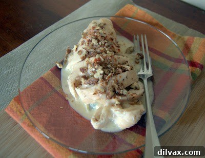 Plated Gorgonzola Pear Chicken, drizzled with sauce and garnished with sugared pecans