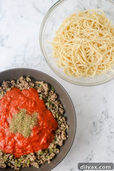Golden Baked Spaghetti 5 Cooked spaghetti and cooked ground beef and pasta sauce ready to be mixed together.