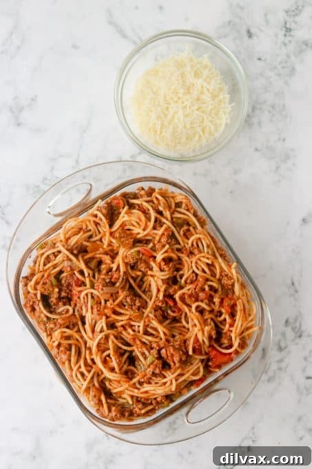 Golden Baked Spaghetti 6 A baking dish of spaghetti with meat sauce and mozzarella cheese ready to be baked.