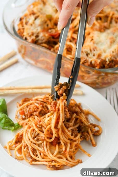 Golden Baked Spaghetti 7 Setting a plate of spaghetti baked in the oven.