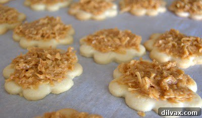 Caramel coconut topping being gently spread onto a baked cookie ring.