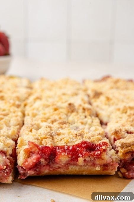 Strawberry Crumble Bars cut into squares on a cooling rack