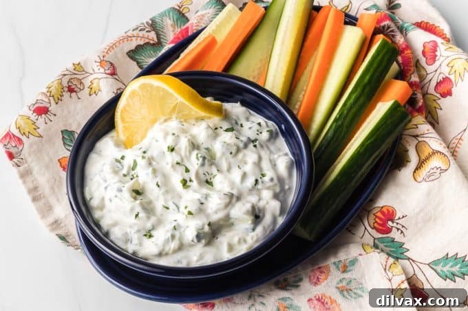 Effortless Greek Tzatziki Dip 2 Easy Homemade Tzatziki Sauce, served in a white bowl with fresh dill garnish.