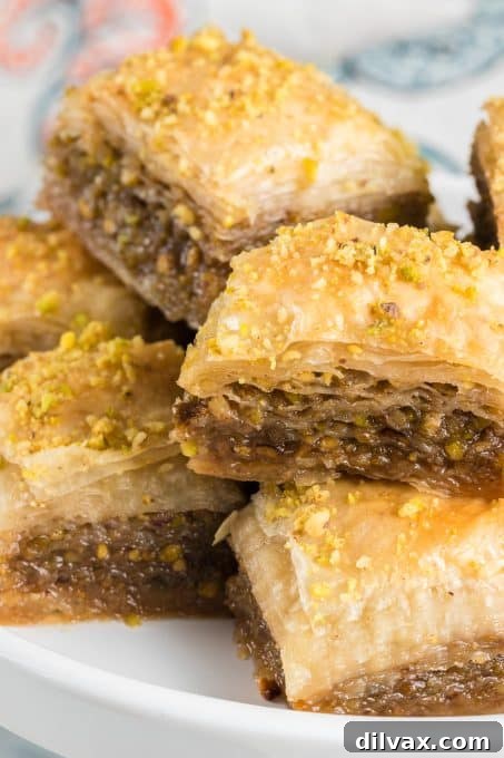 Layers of phyllo dough ready for the nut mixture, featuring chopped walnuts and pistachios