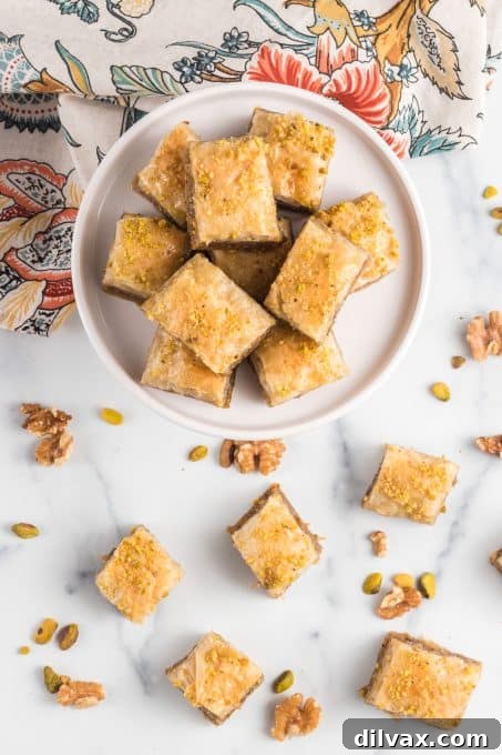 Diamond-shaped pieces of Baklava showcasing the layers of phyllo, nuts, and golden honey syrup