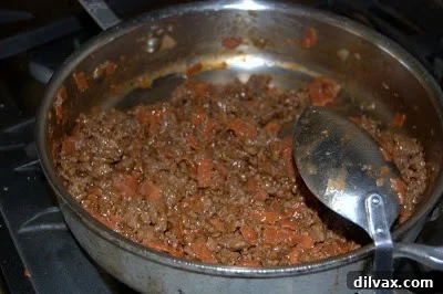 Day 188 Cereal for Dinner 2 Potato Beef Casserole before baking, showcasing layered ingredients and sauce, ready for the oven.