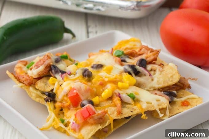 Large platter of BBQ Chicken Nachos, perfect for sharing on game day or as a family dinner.