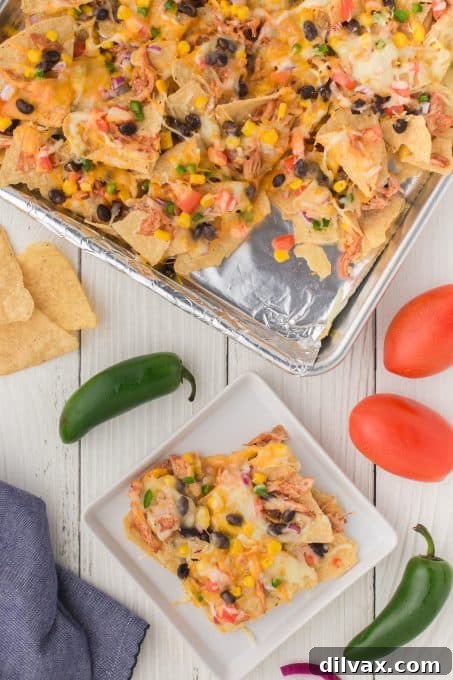 A large platter of nachos with a variety of toppings