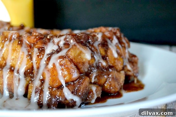 Close-up of a serving of Apple Cinnamon Sweet Rolls Monkey Bread on a plate, showing the gooey apple and cinnamon filling