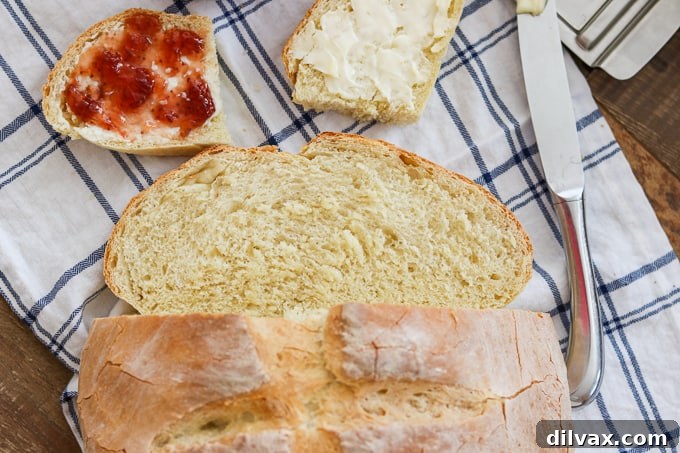 A fresh loaf of Grandma's Italian Bread with two slices cut off, showing its soft interior