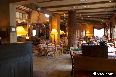 Celebrating 21 Years with Lemon Basil Cookies 3 Intimate dining setting at T. Cook's with flickering candlelight and a cozy atmosphere.