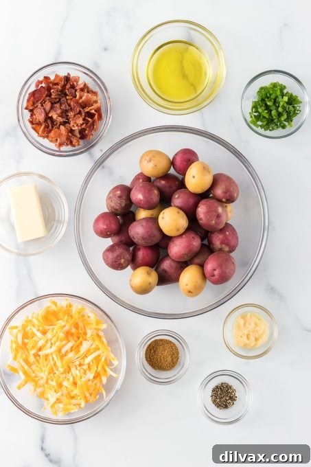 Fully Loaded Crispy Potatoes 4 Assortment of fresh ingredients laid out on a wooden board, including small red potatoes, olive oil, butter, garlic, Old Bay seasoning, green onions, cheese, and crumbled bacon, for Loaded Smashed Potatoes.