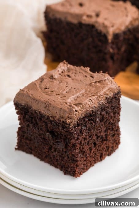 Velvet Buttermilk Chocolate Cake 11 Easy cake made with cocoa and buttermilk for a moist crumb, presented on a wooden board.