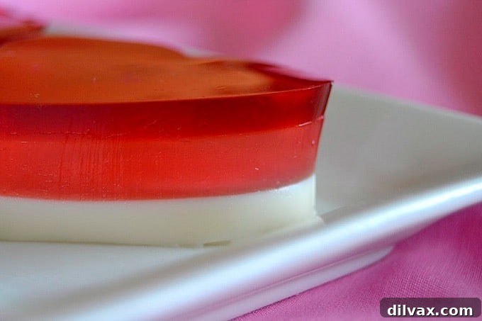 JELL-O Valentine Hearts, a three-layered gelatin dessert, displayed elegantly on a platter, ready for a Valentine's Day celebration.