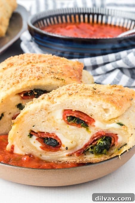 A perfectly golden Spinach Pepperoni Bread, sliced and ready to serve.