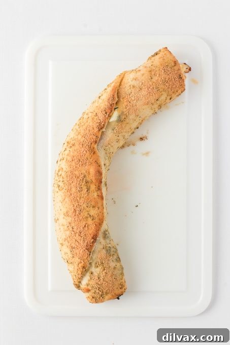 Baked Pepperoni Bread with spinach, sliced to reveal the layers.