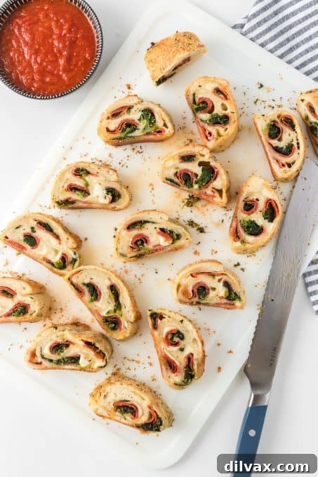 Slices of stuffed bread, revealing layers of spinach, pepperoni, and melted cheese.