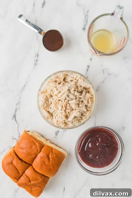 Fresh ingredients laid out for making BBQ Chicken Sliders: slider buns, shredded chicken, barbecue sauce, and A1 sauce.
